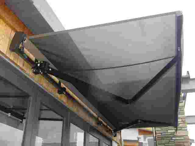 Retractable Awnings - Black Folding arm awning over cafe doors in Karaka 2 copy.jpg