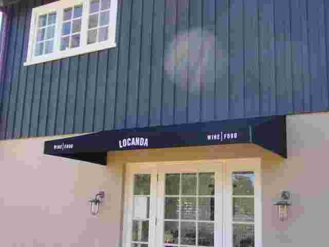 Fixed Frame Awnings - Fixed Frame wedge awning over WIne Tasting room entrance copy.jpg