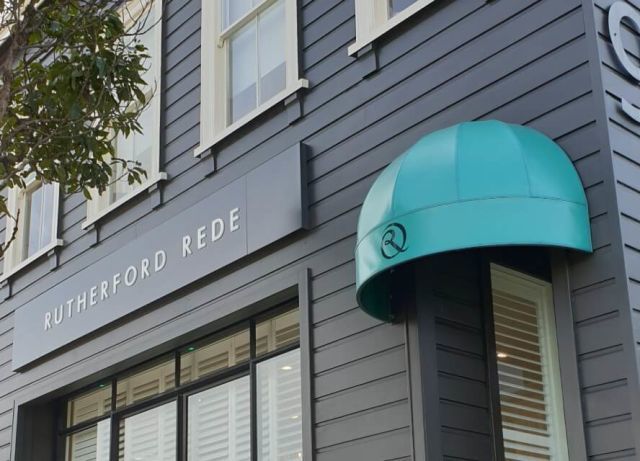 Fixed Frame Awnings - Umbrella Fixed Frame awning over single office entrance in Teal.jpg